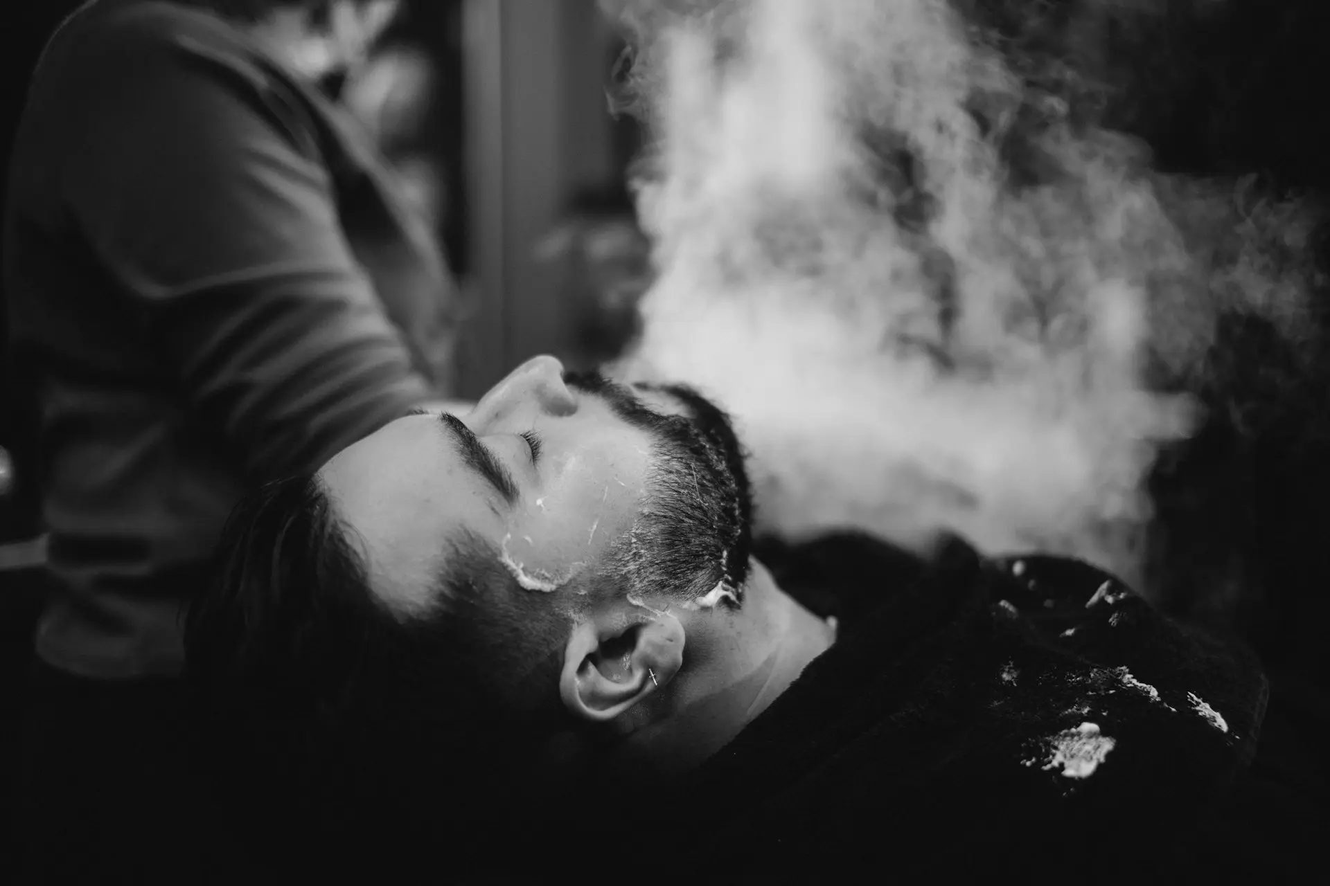 a man laying down with steam coming out of his face